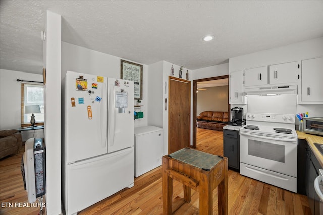 kitchen with light wood finished floors, light countertops, white cabinets, white appliances, and under cabinet range hood