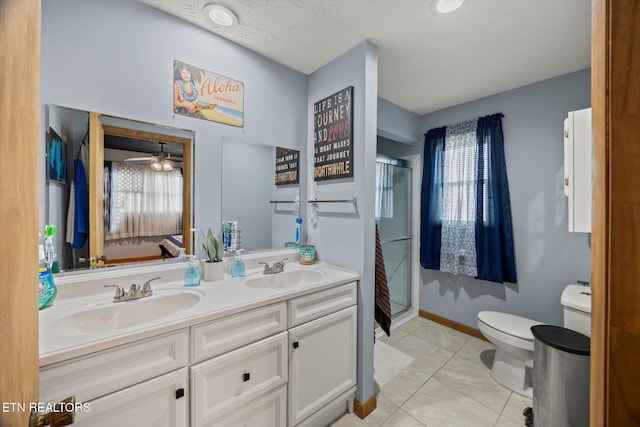 full bathroom with tile patterned flooring, a sink, toilet, and a shower stall