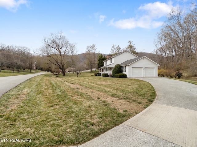 view of home's exterior with a garage, a lawn, and driveway