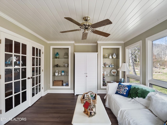 living room featuring built in features, ornamental molding, wood finished floors, wooden ceiling, and baseboards