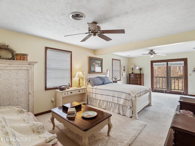 bedroom featuring light carpet, baseboards, visible vents, and a textured ceiling