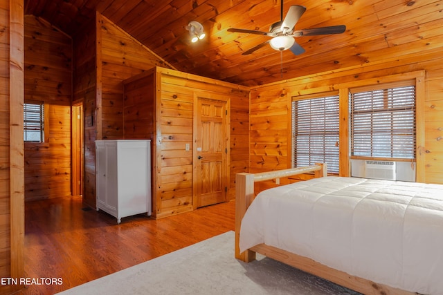 bedroom featuring vaulted ceiling, wood finished floors, wood ceiling, and wood walls