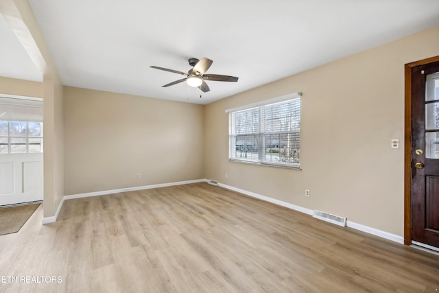 foyer entrance featuring baseboards, visible vents, and a healthy amount of sunlight