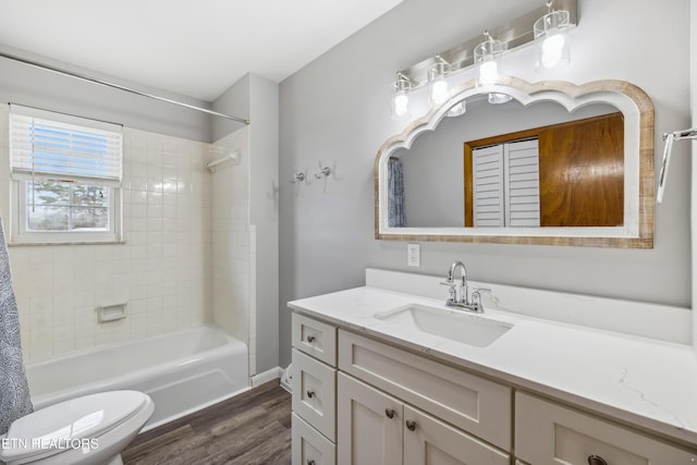 full bathroom with toilet, shower / bath combo, wood finished floors, and vanity