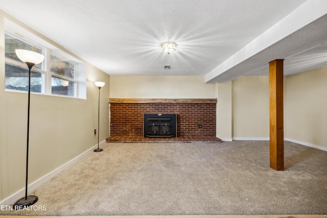 unfurnished living room with carpet, baseboards, and a textured ceiling