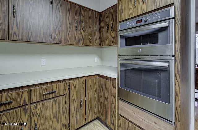 kitchen with double oven and light countertops