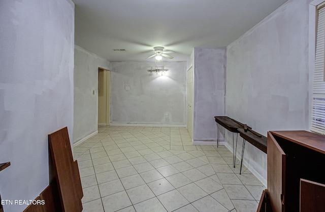 empty room featuring light tile patterned floors and ceiling fan