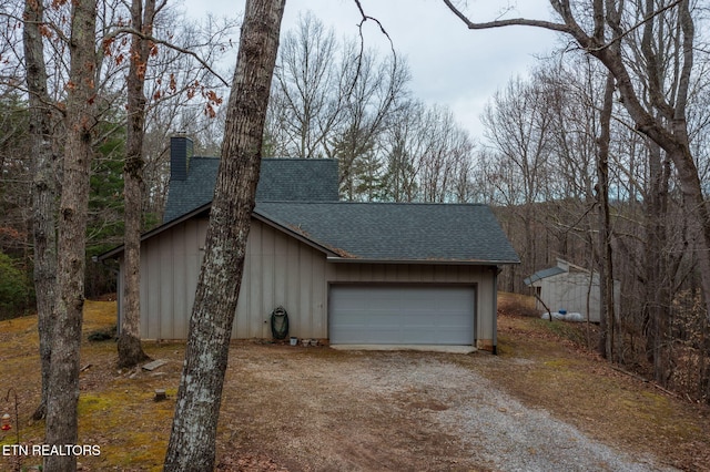 garage with dirt driveway