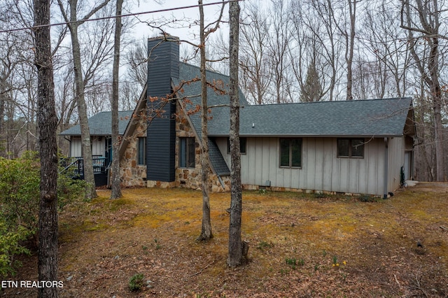 view of front of property with a chimney, board and batten siding, and a shingled roof