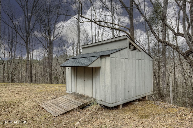 view of shed featuring a wooded view