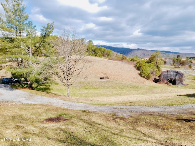 mountain view featuring a rural view