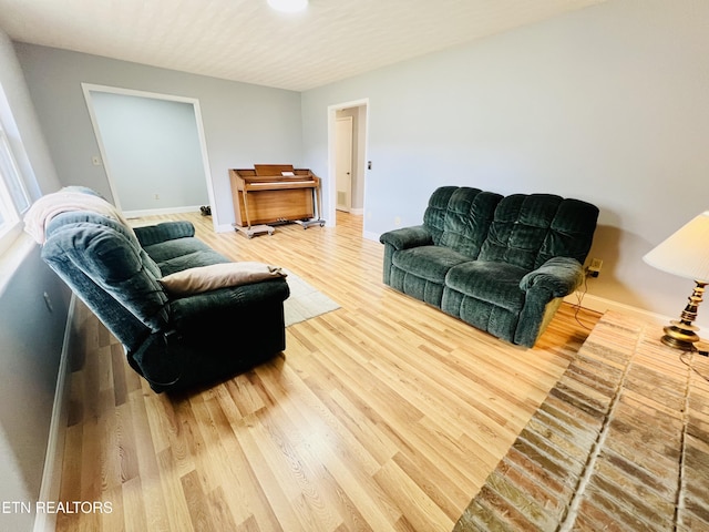 living area featuring light wood-type flooring and baseboards