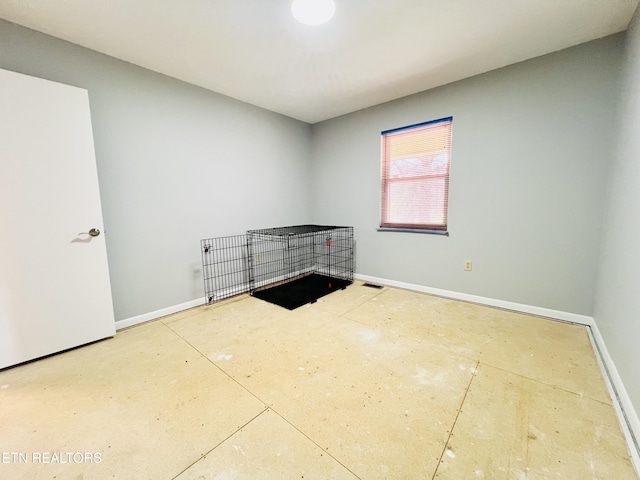 empty room with visible vents and baseboards