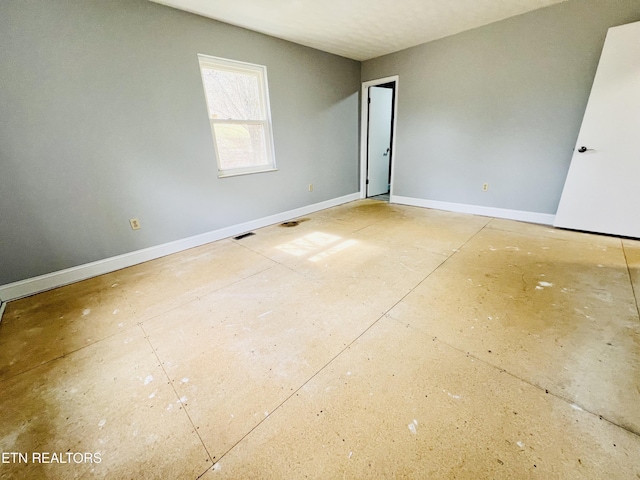 spare room with visible vents and baseboards