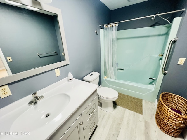 bathroom featuring toilet, shower / bath combo with shower curtain, wood finished floors, and vanity