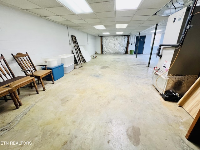 finished basement featuring a paneled ceiling