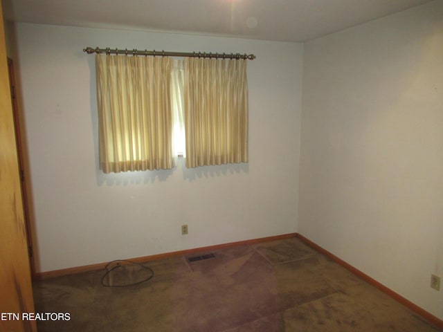 carpeted empty room with visible vents and baseboards