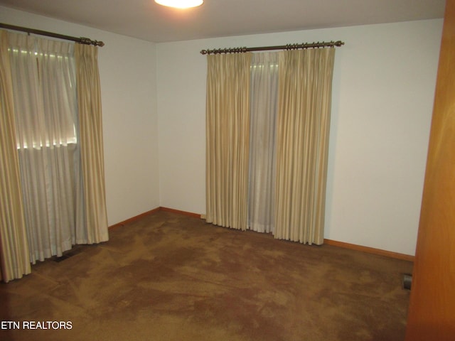 empty room with carpet flooring and baseboards