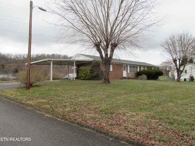 ranch-style home featuring driveway and a front yard