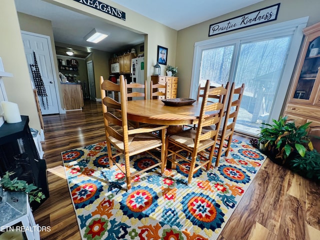 dining space with wood finished floors