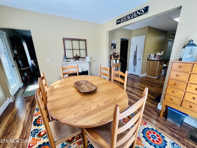 dining room with visible vents, baseboards, and wood finished floors