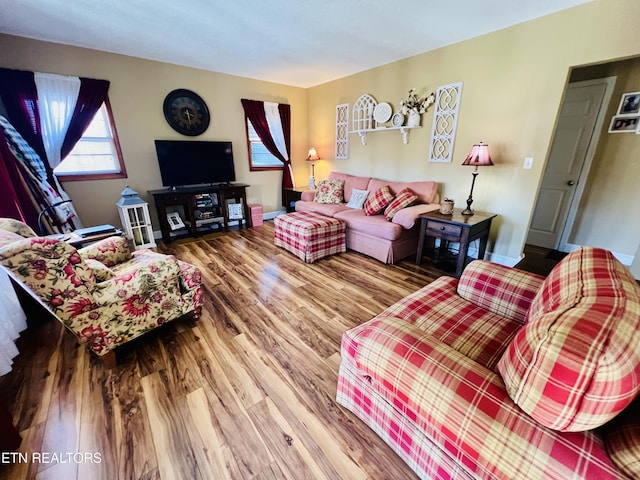 living room with baseboards and wood finished floors