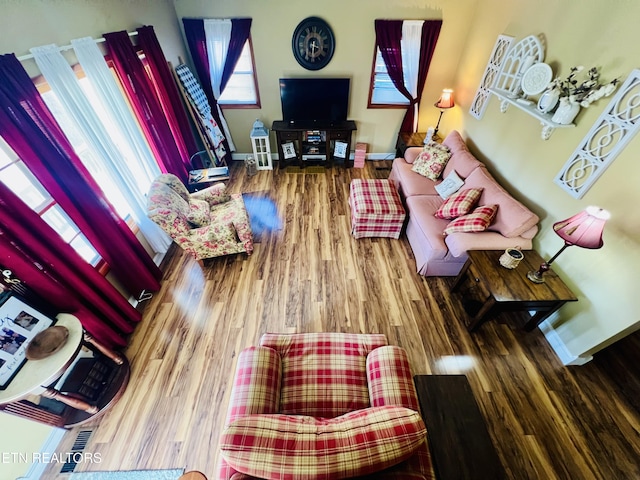 living room with baseboards and wood finished floors