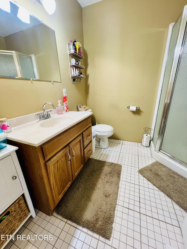 full bath featuring tile patterned floors, a shower stall, and vanity