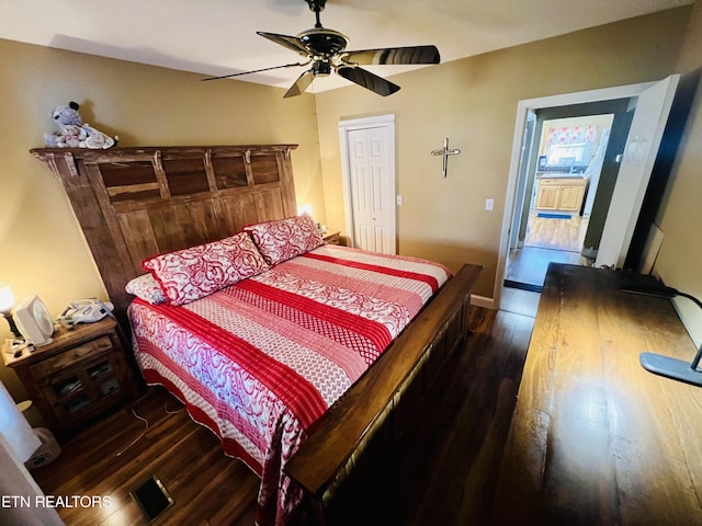 bedroom with baseboards, wood finished floors, and a ceiling fan