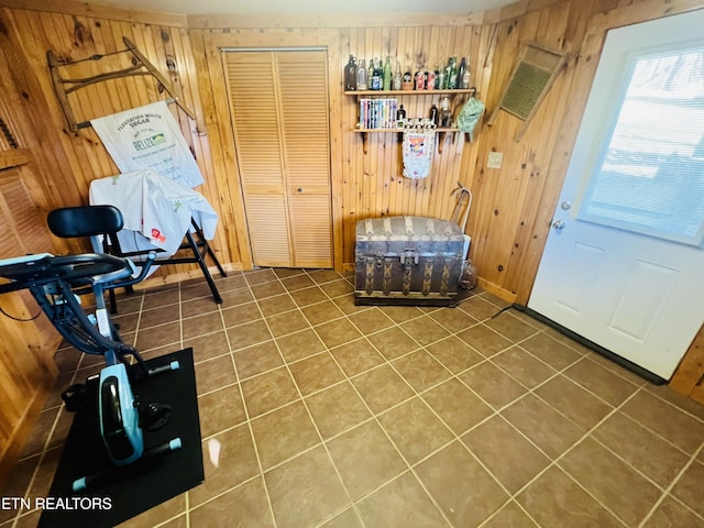 tiled foyer entrance featuring wood walls