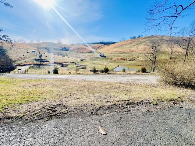 view of mountain feature featuring a water view and a rural view