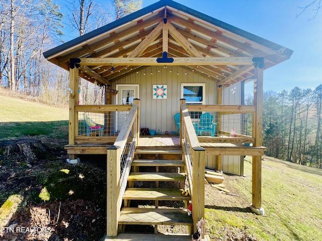 doorway to property featuring a wooden deck and a yard