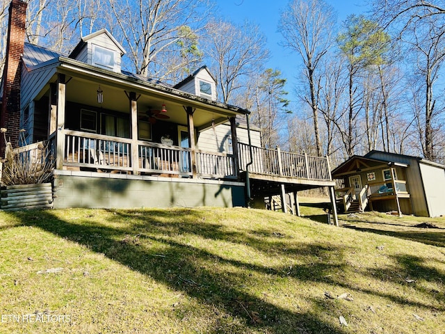 view of property exterior with a chimney, a wooden deck, and a yard