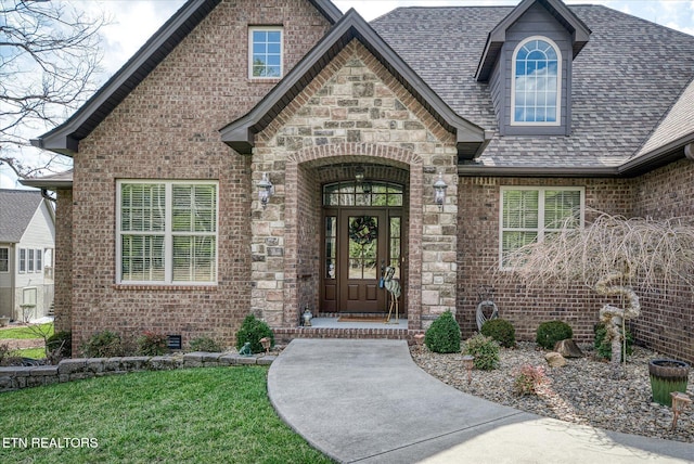 12 Inwood Dr, Fairfield Glade, TN 38558 - view of exterior entry featuring crawl space, brick siding, and roof with shingles