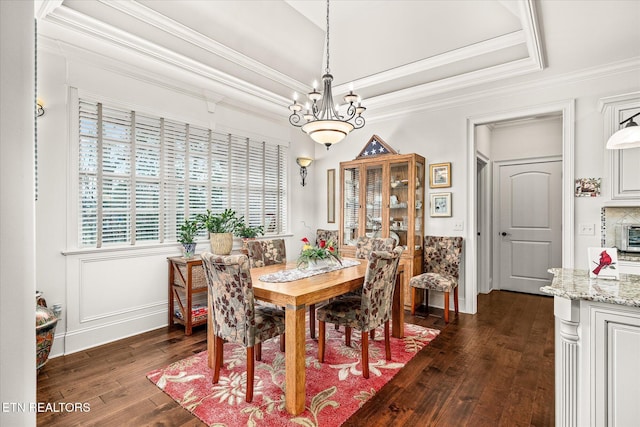12 Inwood Dr, Fairfield Glade, TN 38558 - dining area with dark wood-type flooring, ornamental molding, a tray ceiling, baseboards, and a chandelier