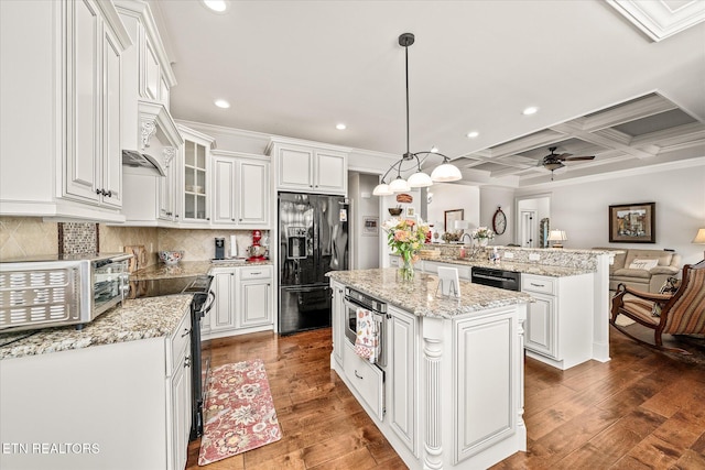 12 Inwood Dr, Fairfield Glade, TN 38558 - kitchen with a center island, dark wood-type flooring, ceiling fan, electric range, and black fridge with ice dispenser