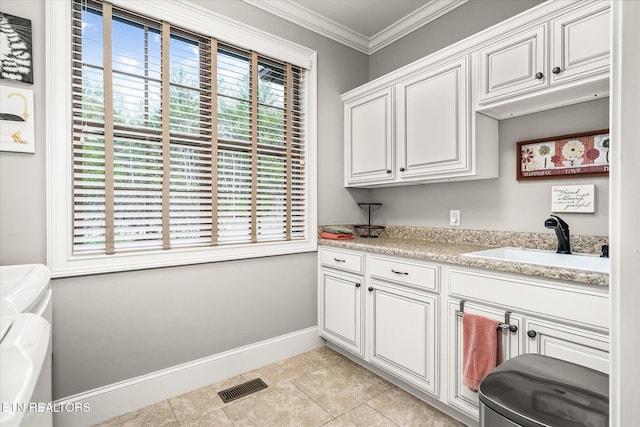 12 Inwood Dr, Fairfield Glade, TN 38558 - washroom featuring visible vents, washing machine and dryer, ornamental molding, cabinet space, and a sink