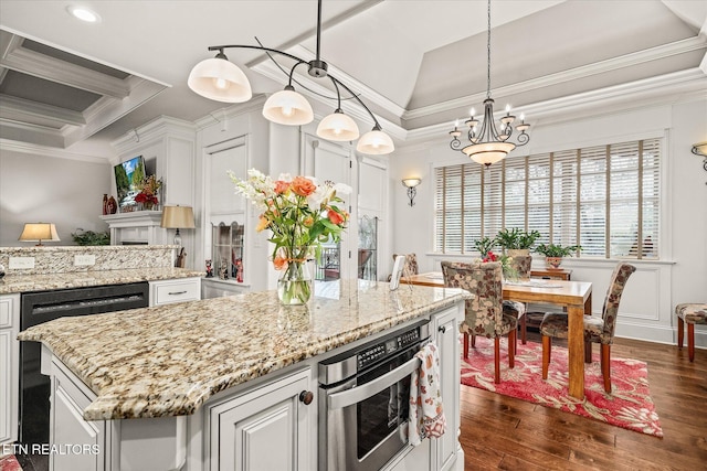 12 Inwood Dr, Fairfield Glade, TN 38558 - kitchen featuring light stone countertops, ornamental molding, dark wood-type flooring, a notable chandelier, and a center island