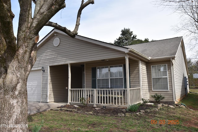 ranch-style house featuring a garage, covered porch, and a shingled roof