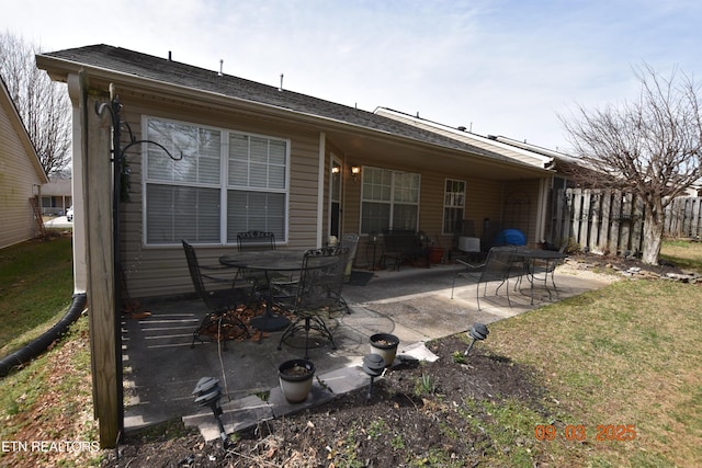 back of house with a patio and fence