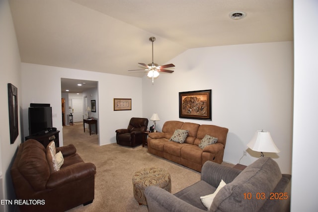 living room featuring carpet flooring, ceiling fan, and vaulted ceiling