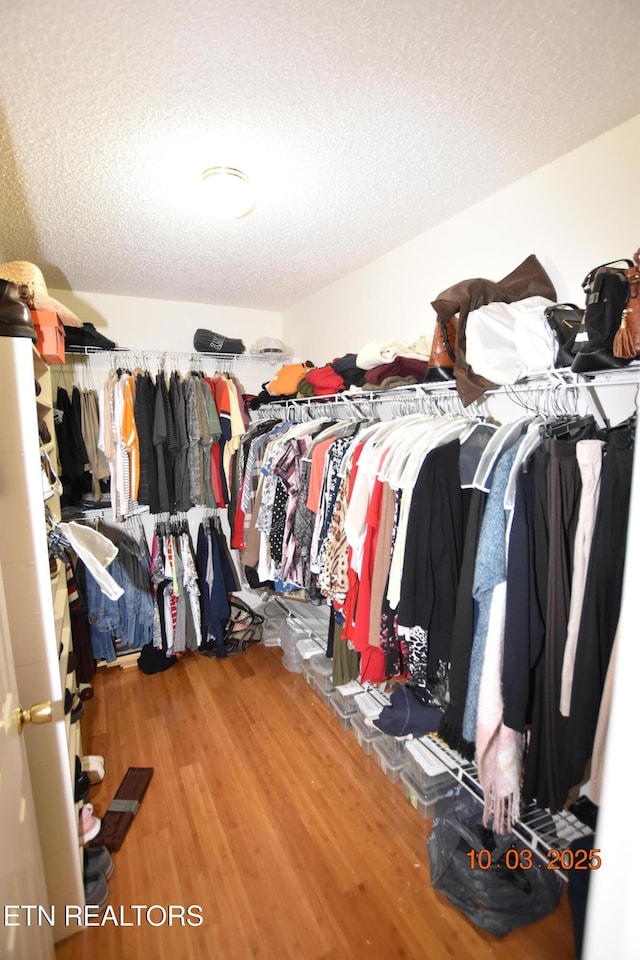 spacious closet with wood finished floors