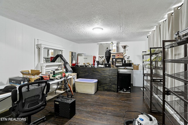 office area with a textured ceiling and wood finished floors