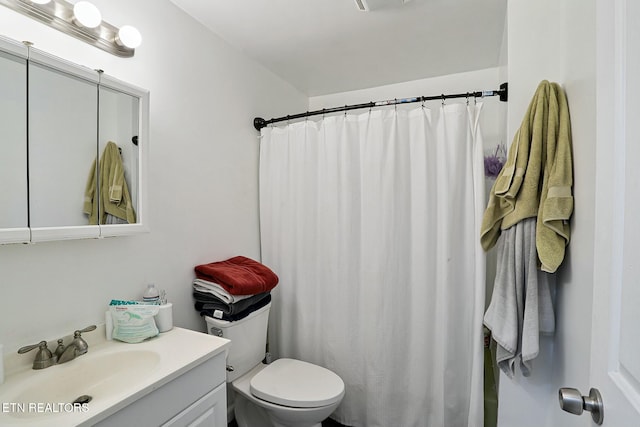 bathroom featuring vanity, toilet, and a shower with curtain