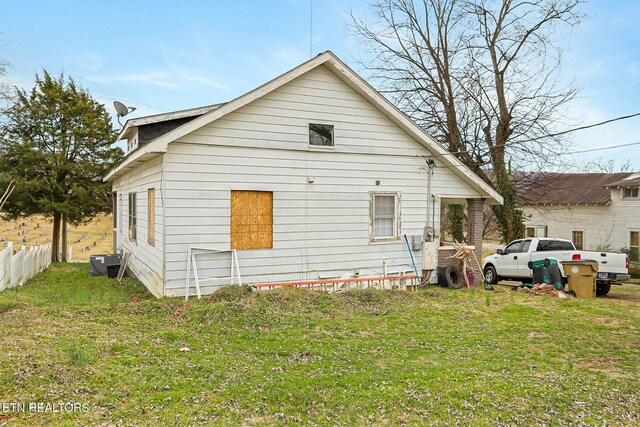 back of property featuring a yard