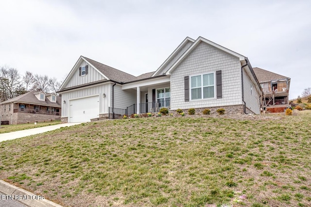 ranch-style house featuring board and batten siding, an attached garage, driveway, and a front yard