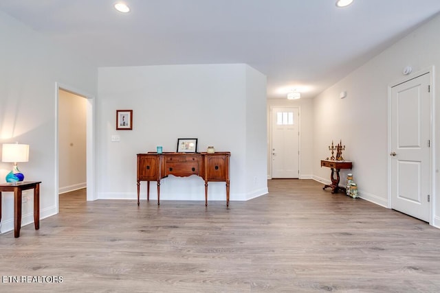 interior space with recessed lighting, baseboards, and wood finished floors