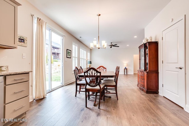 dining space featuring light wood finished floors, a notable chandelier, recessed lighting, and baseboards