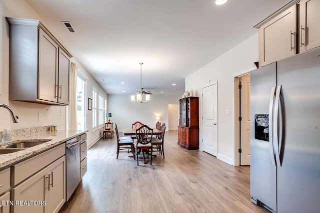 kitchen with visible vents, stainless steel appliances, light wood-type flooring, and a sink