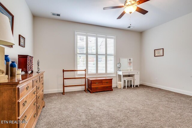 interior space featuring visible vents, baseboards, light colored carpet, and ceiling fan